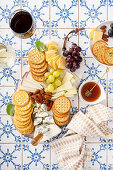 Cheese board with crackers, nuts and grapes