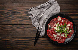 Italien beef carpaccio with parmesan cheese and arugula