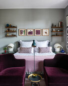 Pair of velvet armchairs at the foot of a bed