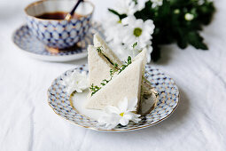 Sandwich with cream cheese and herbs on set tea table