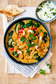 Red lentil and sweet potato curry with spinach and cashew nuts
