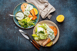 Healthy food meal grilled salmon steaks with dill sauce and salad leafs