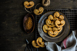 Traditional Puff pastry spiral biscuits known as a pig s ears on plate with sugar