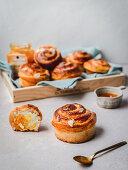 Cinnamon buns with almond flakes served with jam and honey