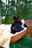 Boat with bath towel and teddy bear in the forest - gift idea for children