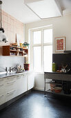 A kitchen made up of various elements with a black floor