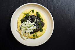 Squid served in its Ink with salsa verde and polenta