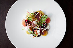 Beet salad with goat cheese on a white plate