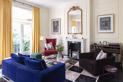 Comfortable seating on chequered rug in front of fireplace in living room