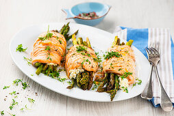 salmon roulades filled with curd cheese and green asparagus