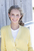 Boy, blonde woman in white top and yellow cardigan