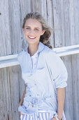 Young, blond woman in light blue shirt blouse