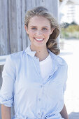 Boy, blond woman in white top and light blue shirt blouse