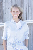 Boy, blond woman in white top and light blue shirt blouse