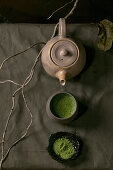 Traditional japanese hot green frothy tea matcha in ceramic cup, powdered matcha, hand craft teapot