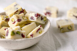 Homemade white chocolate candy bar with pistachios nuts and cranberries