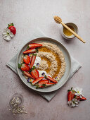 Plate of strawberry porridge on a table in the kitchen