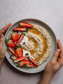 Plate of strawberry porridge on a table in the kitchen