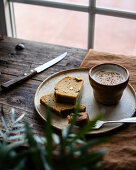 Slices of tasty fresh wholegrain loaf served on plate with cup of fresh milk