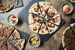 A selection of pizzas on slate platters