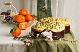 Colomba di Pasqua (Traditional Italian Easter dove cake with almonds in the shape of a dove) with green pistachio icing