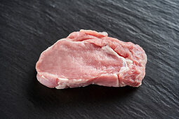 Raw pork on a black background