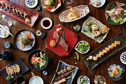 A selection of Japanese dishes, including sushi, terayki skewers and gyoza
