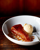 A piece of tarte tatin with vanilla ice cream