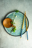Spring table setting with first leaves and flowers of cherry tree served