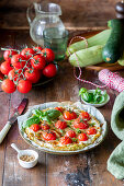 Zucchini base pizza with cherry tomatoes