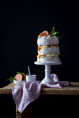 A three-tier meringue cake with blood oranges