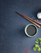 Bowl of soy sauce and chopsticks