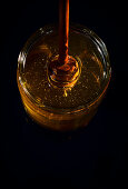 Pot of honey with honey spoon