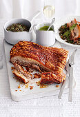 Smoked salt-crusted pork with lentils and caper sauce