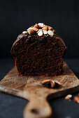 Spiced cake with nuts, sliced on a wooden board