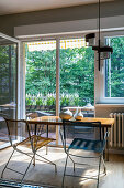 Kitchen table with chairs in front of balcony door