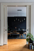 View through open sliding doors to dining room with black walls