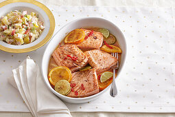 Salmon marinated in citrus juice with potato and apple salad