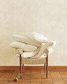 Pillows without cases piled on an armchair