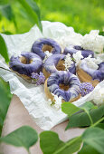 Vegan cinnamon donuts with lilac syrup, topped with marble icing