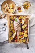 Oven-baked gilthead with Mediterranean vegetables and lemons
