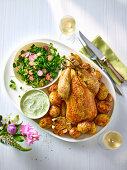 Roast chicken over new potatoes dill aioli and pea salad