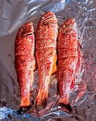 Stuffed red mullets on aluminium foil