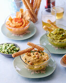 Three kinds of hummus with sesame sticks