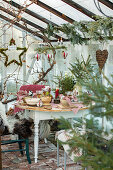 Set table in the greenhouse with Christmas decorations