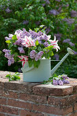 Bouquet of lilac and tulip 'Marilyn' in a watering can