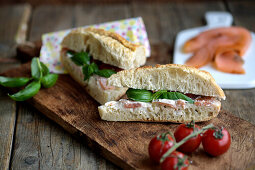 Sandwich with smoked salmon, tomato, and basil