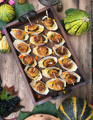 Pumpkin cakes with edible flowers and pesto on pumpkin bread