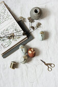 Easter eggs with botanical motifs, book, ceramic vase and peacock-shaped scissors