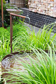 Garden fountain with rusty vessel